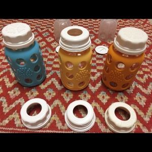Three 4 ounce life factory bottles w assorted tops